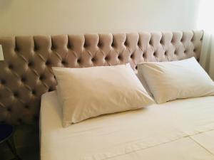 a bed with two white pillows on it at 410 Everest Flat Service in Caldas Novas
