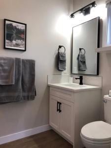 a bathroom with a white sink and a mirror at Mountain View Bed & Breakfast in Banff +35 photos
