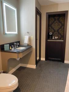 a bathroom with a toilet and a sink at Place D'Armes Hotel in New Orleans +24 photos