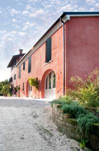 a red brick building with windows and a driveway at Casa Carrer B&B in San Giovanni di Livenza