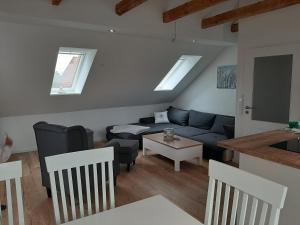 a living room with a couch and a table at Nordstern in Tönning