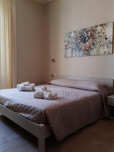 a bed sitting in a bedroom next to a wall at Affittacamere Stazione Empoli in Empoli