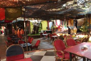 a restaurant with tables and chairs and a tree at Zenobia Leisure in Anjuna