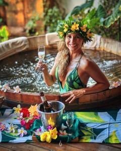 a woman holding a glass of wine in a hot tub at Hare Nua Hotel Boutique in Hanga Roa