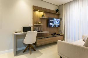 a room with a desk with a computer and a chair at Pool | Food hall | 450m from the mall #CA03 in Florianópolis