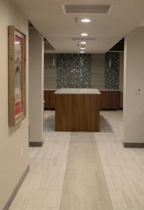 an empty office lobby with a reception desk and tile floors at Best Western Plus Executive Residency Waterloo & Cedar Falls in Waterloo