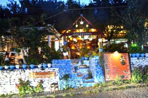 a garden center with a building with lights at Sirincem Pension in Selcuk