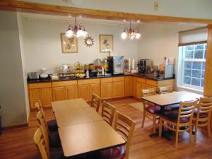 a kitchen with two tables and chairs and a counter at Bellis Inn in Bellingham