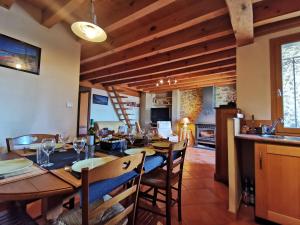 a dining room with a long table and chairs at Anthémis I, II, III in Les Angles