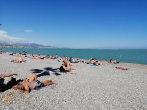 eine Gruppe von Menschen, die am Strand liegen in der Unterkunft STUDIO MARINA BAIE DES ANGES in Villeneuve-Loubet