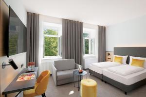 Postel nebo postele na pokoji v ubytování Stadthotel Oberndorf - 24h Self Check-In Terminal + 33 fotografií
