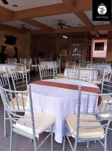 a room with a large table with chairs and a ceiling at Asian Village Tagaytay in Tagaytay