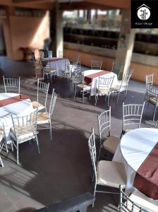 a group of tables and chairs with white tables at Asian Village Tagaytay in Tagaytay