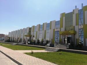 a large building with aania on the side of it at Aсe Hotel in Aktobe