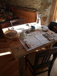 un tavolo in legno con una tovaglia; di B & B La Guiette a Casteldelfino