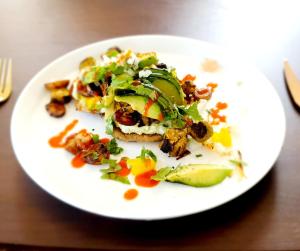 a white plate of food on a table at The Sleeping Dog Room at The Grumpy Schnauzer BnB Huge Room, Luxe Suite, Private Hot Tub, Breakfast, Gym, Games Room, Farm Stay, Amazing in Airdrie