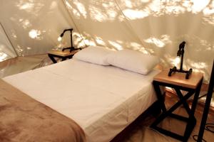 a bedroom with a bed in a tent at La Posada en el Potrero Chico in Hidalgo