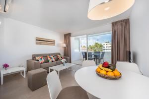 a living room and dining room with a table and chairs at Camelina Suites in San Antonio Bay