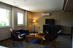 a living room with a couch and a table and chairs at Terra Malal in Chos Malal