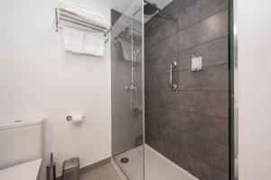 a bathroom with a shower with a glass door at Camelina Suites in San Antonio Bay