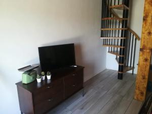 a living room with a flat screen tv on a dresser at Skalameri in Kozljak