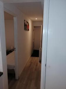 a hallway leading to a bedroom with a bed at Apartment StayWell Amsterdam Free Parking in Amsterdam