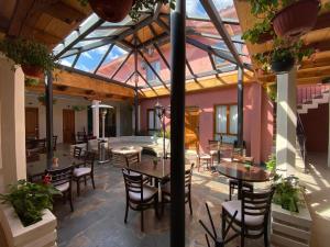 a patio with tables and chairs in a building at Hotel Villa Murano in San Cristóbal de Las Casas