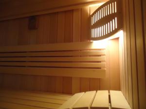 a bench in a sauna with a light on it at Lipizzaner Lodge Guest House in Postojna