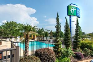 a pool at a resort with a sign and plants at Holiday Inn Express Hotel & Suites Anderson I-85 - HWY 76, Exit 19B by IHG in Anderson