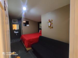 a small room with a red bed and a sink at La Vid Posada Inn in Valle de Guadalupe +14 photos