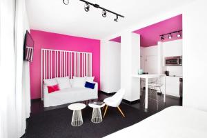 a bedroom with a white bed and a purple wall at Blanc Kara- Adults Only in Miami Beach