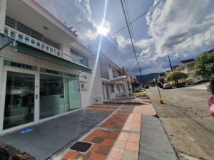 a building on a street with the sun in the sky at Hotel Royal Plaza in Villavicencio