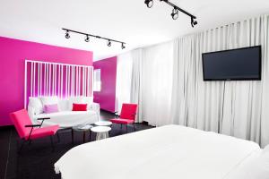 a hotel room with a bed and a tv at Blanc Kara- Adults Only in Miami Beach
