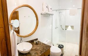 a bathroom with a toilet a sink and a mirror at Casa Passiflora Hotel Boutique in Jardin