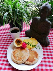 a plate of food with eggs and pancakes on a table at Bodhi Hostel & Lounge in Valle de Anton