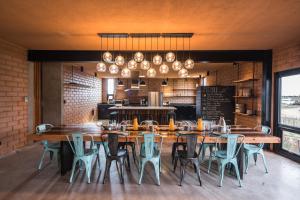 a dining room with a large wooden table and chairs at Santulan in Valle de Guadalupe