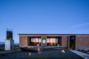a brick house with a fireplace in front of it at Santulan in Valle de Guadalupe