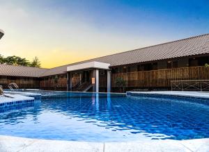 a large swimming pool in front of a building at Jatiluhur Valley Resort in Purwakarta