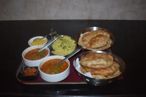 a tray with different types of food on a table at Hotel Siddhartha Inn in Udaipur