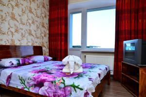 a bedroom with a bed with a stuffed elephant on it at Героїв Танкістів, 8 in Fastov