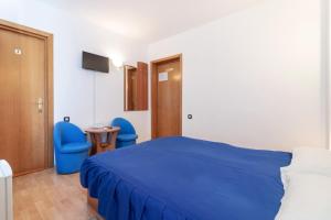 a bedroom with a blue bed and two blue chairs at Casa Din Noua in Braşov +33 photos