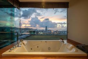 a bath room with a large window and a large clock at The Senses Resort & Pool Villas - SHA Plus in Patong Beach