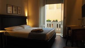 a bedroom with a bed and a large window at Al Sale in Cagliari