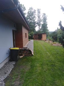 a house with a yard next to a building at Bungalov v Krásné Lípě in Krásná Lípa