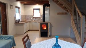 a kitchen with a table and a stove in a room at Domek u Kasi in Wąglikowice