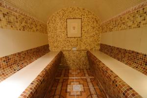 a small room with tiles on the walls at Pegasa Pils Spa Hotel in Jūrmala