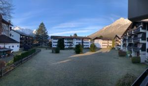 a group of buildings with mountains in the background at AlpenTraum in Garmisch-Partenkirchen
