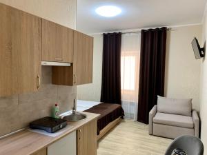 a small room with a bed and a sink at Отель Южный Двор in Kharkiv