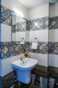 a bathroom with a blue sink and a shower at Suraksha Stay ITPL Hotel Banglore in Bangalore