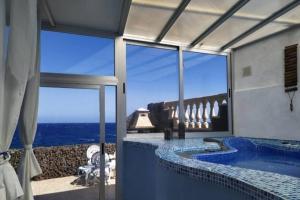 a bathroom with a swimming pool with a view of the ocean at Romantic Tenerife in Güimar